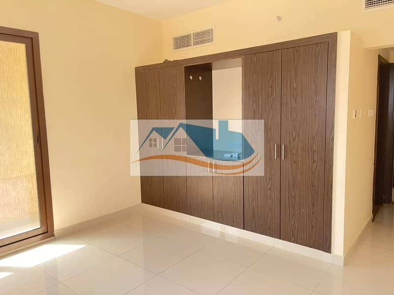 Two rooms and a hall, a family building with surveillance cameras. Payment facilities: 4-6 cheques. Near To El Hekma Private School. Excellent wall cabinets and space.
