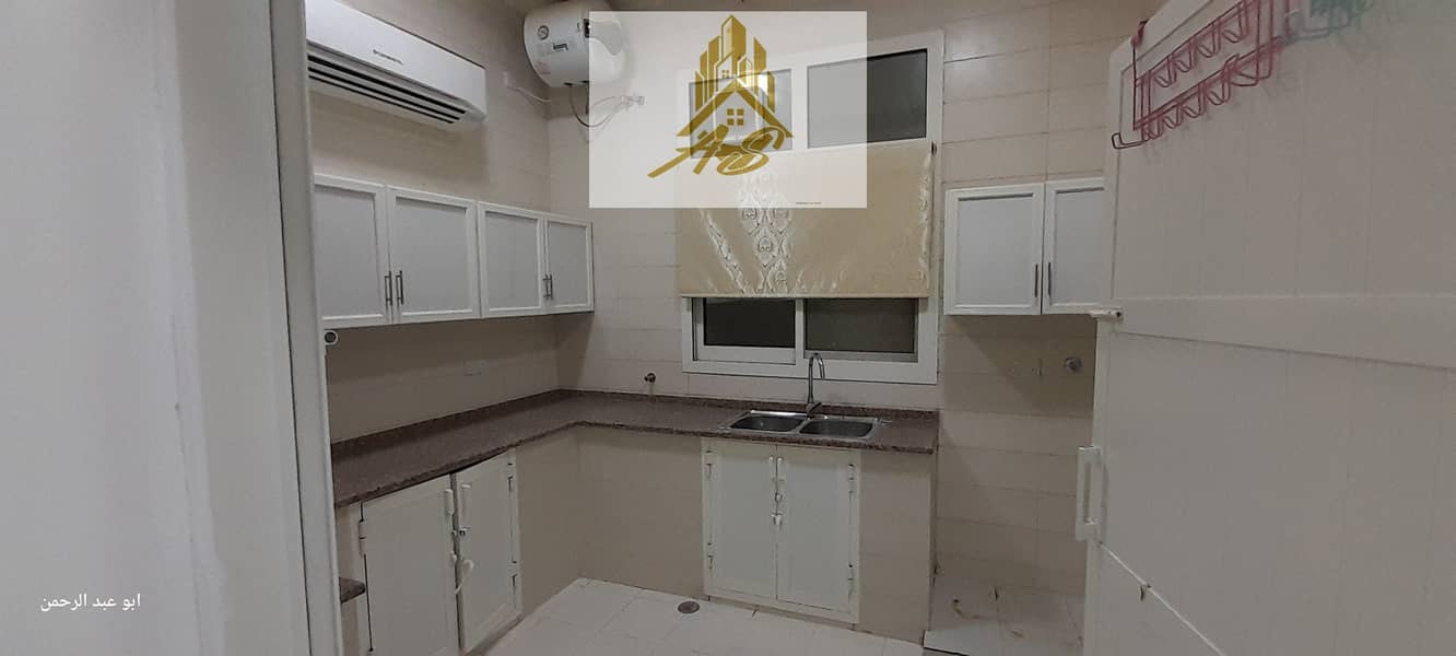 For rent in Al Bahia, behind Deerfields Mall, an apartment on the first floor, two rooms, a hall, a maid’s room, and a kitchen
