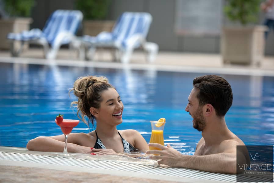 6 Ghaya Grand Hotel Dubai -Swimming Pool Lifestyle Image 2. jpg