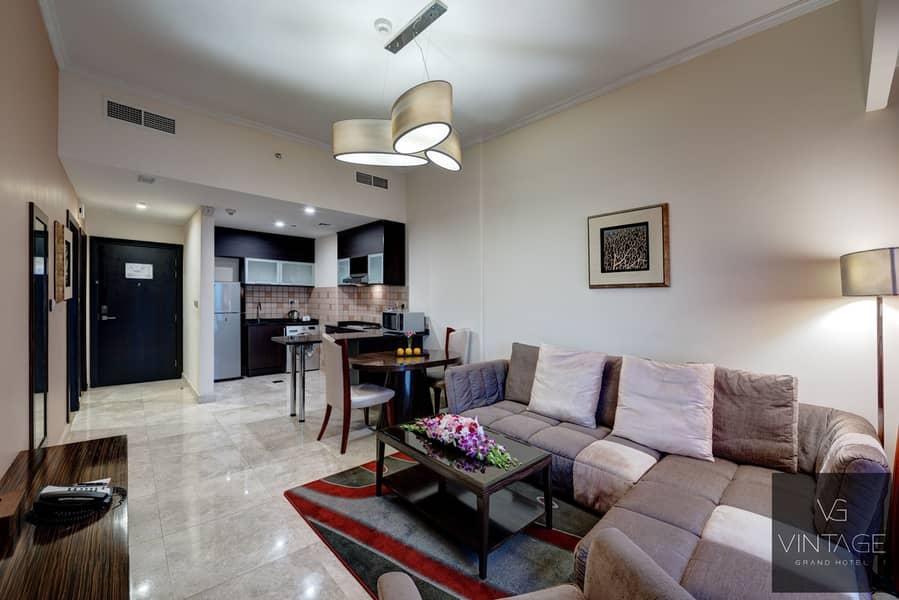 3 Ghaya Grand Hotel Dubai- One Bedroom Sitting Room 1. jpg
