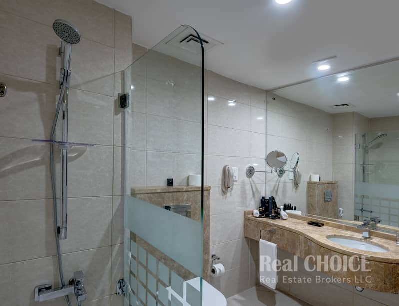 7 Ghaya Grand Hotel Dubai - One Bedroom Bathroom 1. jpg