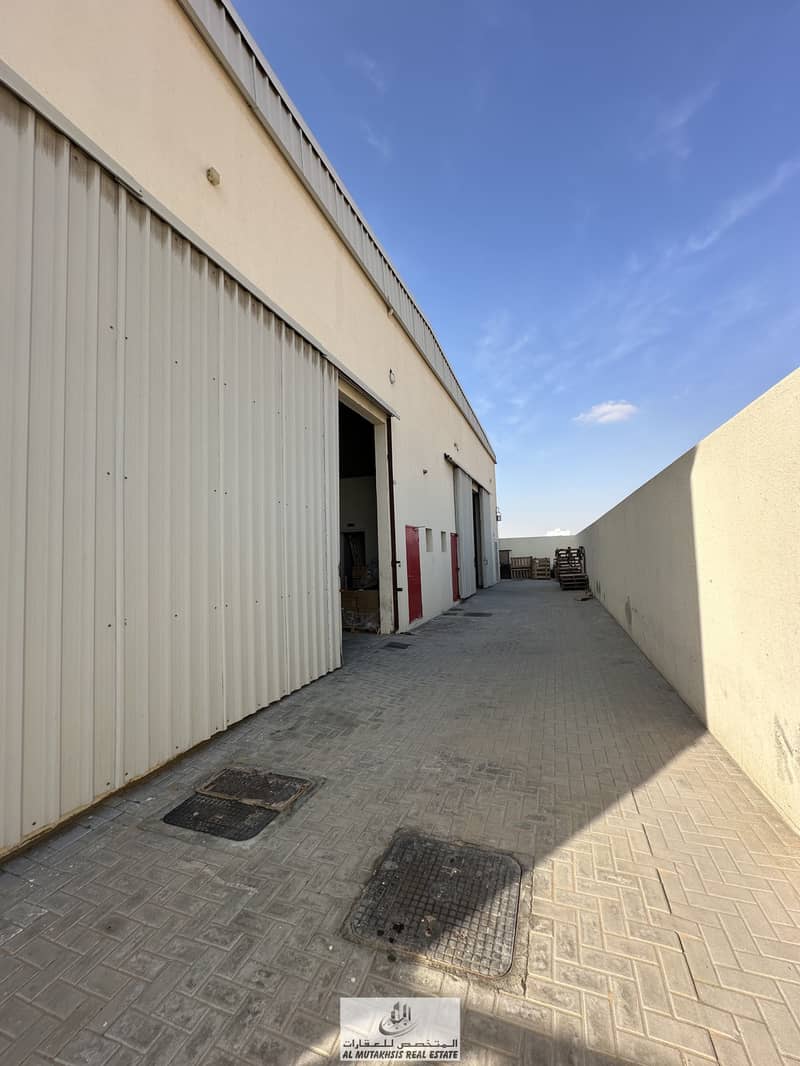 For sale, a built-up land in Al-Saja’a, an industrial area in Sharjah, with 2 warehouses built on it and rented, with an income of 110 thousand dirhams annually.