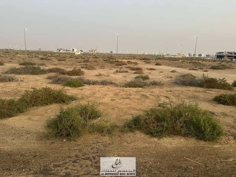 For sale, commercial and residential land in the Tilal project, freehold, area of ​​8,000 square feet, ground building permit + 3 floors, on Emirates Transit Road and near Tilal Mall.