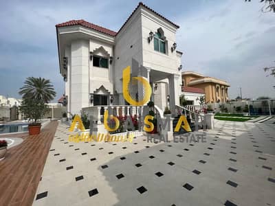 For sale, a luxurious two-storey corner villa in Sharjah, Sharqan area, covered with white Syrian stone, owned by citizens and Gulf Cooperation Counci