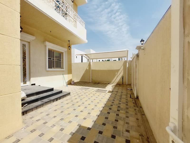 Two-storey villa for rent in Ajman, Al-Hilw area, 3 master bedrooms, a council, a lounge, a maid's room, a corner, two streets, an internal umbrella and an external umbrella, the first resident