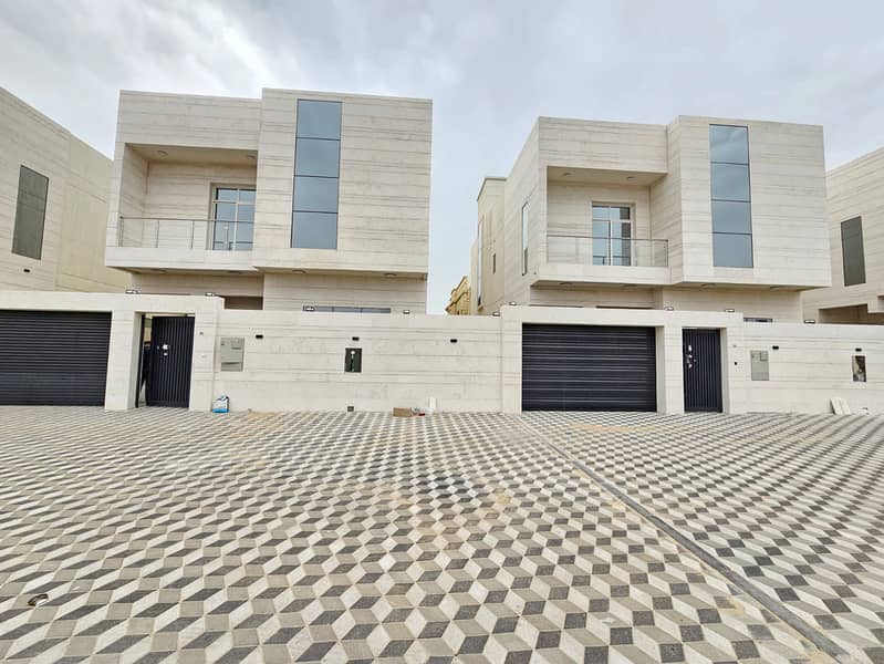 A villa for rent in Ajman, Jasmine area, a large European design consisting of a floor, a first and a roof, with a council, a lounge, a kitchen and five master bedrooms.