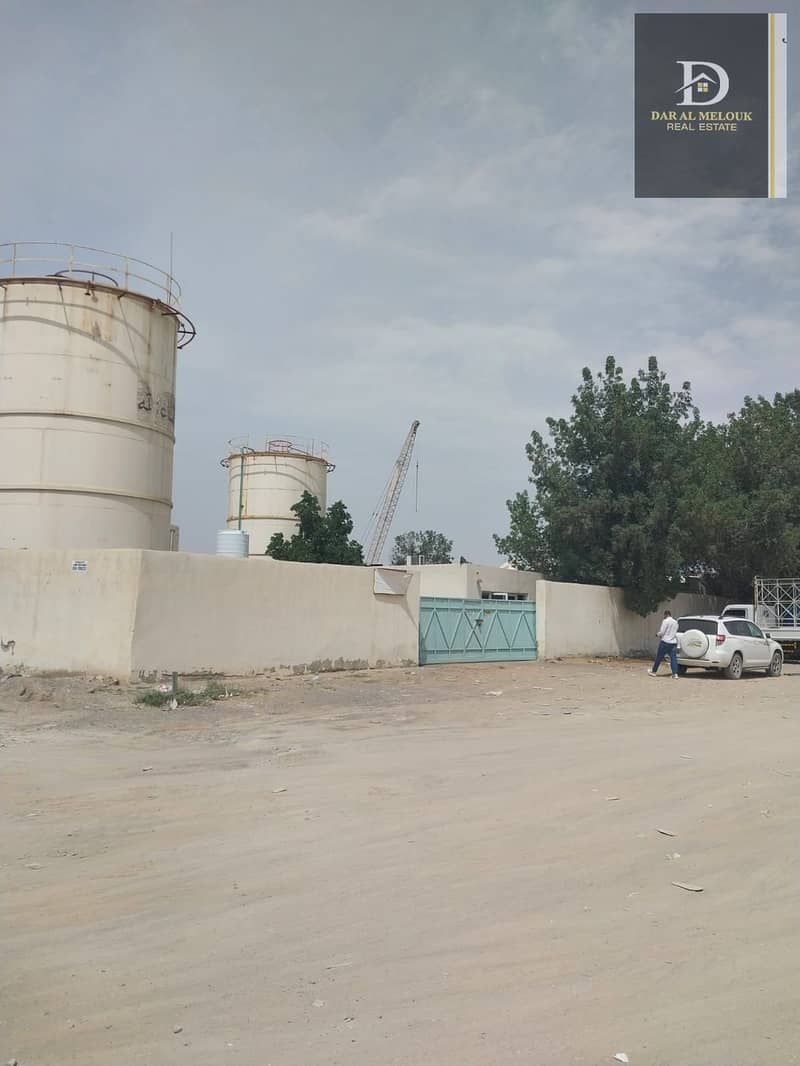 For sale in Sharjah, Al Sajaa Industrial Area, fenced land, area of ​​20,000 square feet, with an enclosure.