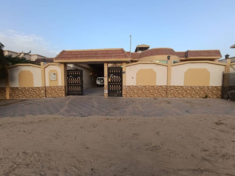 Ground floor villa for rent in Ajman, Al Rawda 2 area 7 bedrooms, a living room and a living room With air conditioners An area of ​​6400 square feet 100 thousand dirhams required