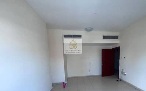 Two rooms and a hall for annual rent in Ajman, large area, 2 bathrooms, balcony, and wall cabinets in Al Nuaimiya, close to Al Hekma School and all se