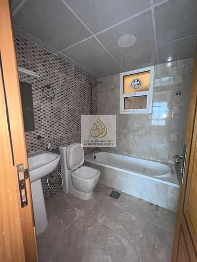 For rent in Ajman, a two-room apartment and a living room with 2 bathrooms, with a balcony and an open view, in Al Rawda 2, opposite Kenzi Hypermarket