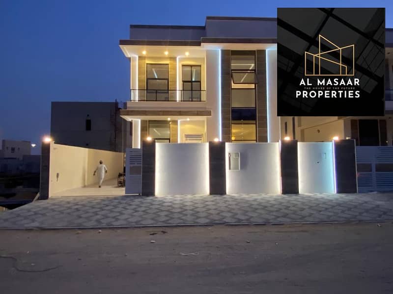 Villa in the most prestigious areas of Ajman, including registration and ownership fees, with a distinctive modern design, a stone facade with a large