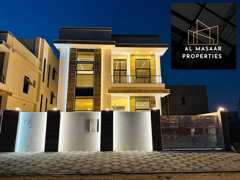 Inclusive of registration fees | For sale, a villa in the most prestigious areas of Ajman, with a distinctive modern design, a stone facade, with a la