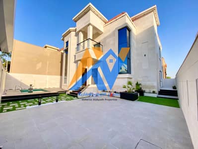House for sale with water and electricity in Ajman, freehold for all nationalities, stone face, very large design and spaces, with a swimming pool and an indoor garden.