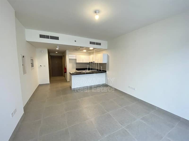 2 soho-square-saadiyat-studio-apartment-open-kitchen-and-living-room-studio-door-entrance-and-central-ac. jpg