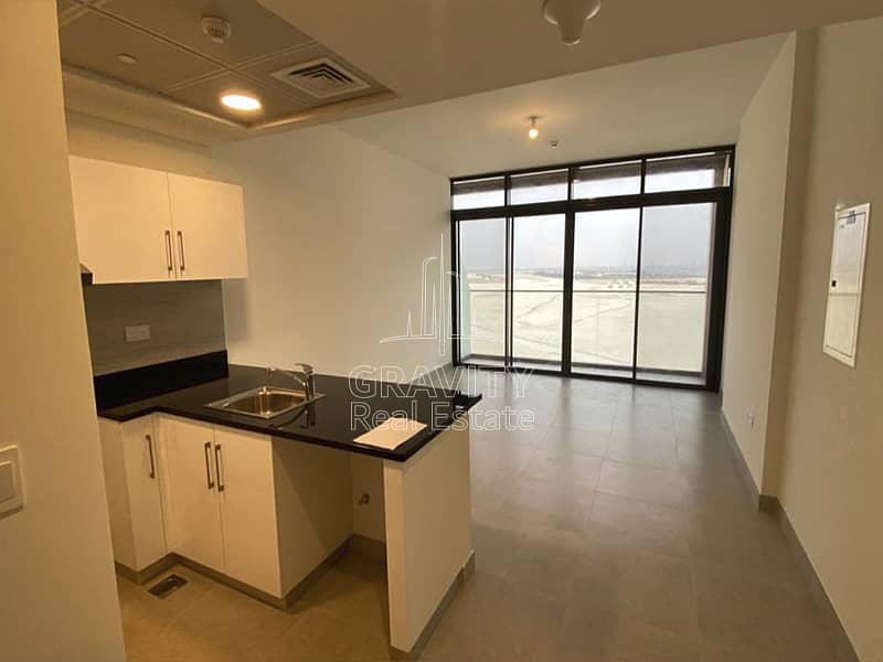 6 soho-square-saadiyat-open-kitchen-and-fire-detector-and-living-room-with-balcony. jpg