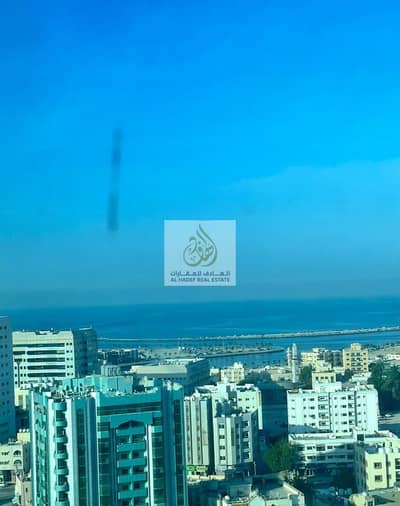 A room and a hall with 2 bathrooms, free air conditioning, with a balcony, excellent, open and high sea view, a prime location in Al Bustan, close to