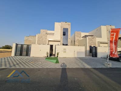 A luxury villa in Al Helio, Ajman, including registration fees and electricity and water connections, without down payment and without annual maintena