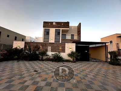 For sale, a villa in the most prestigious places in Ajman, very excellent location, personal finishing, freehold, without down payment, stone facade,