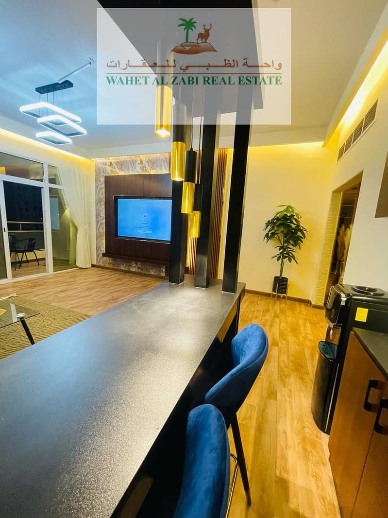 For rent in Ajman, a furnished apartment with two rooms and a hall, a