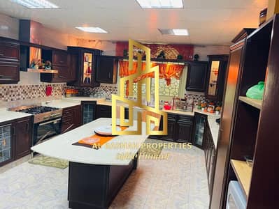 For sale, a two-storey corner villa in Sharjah, Wasit Suburb, Al Quoz area