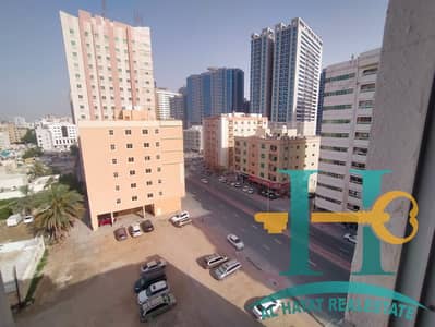Available for annual rent in Al Rashidiya 3 - Ajman, a room, a hall, a bathroom, a kitchen, a balcony, and wall cabinets at a special price