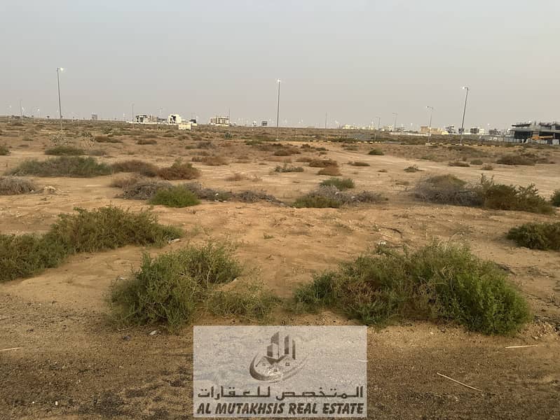 For sale, commercial and residential land in the Tilal project, freehold, area of ​​8,000 square feet, ground building permit + 3 floors, on Emirates Transit Road and near Tilal Mall.
