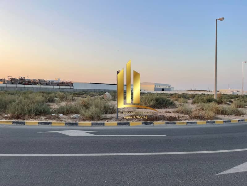 For sale, commercial corner land overlooking the garden in Sharjah, Al