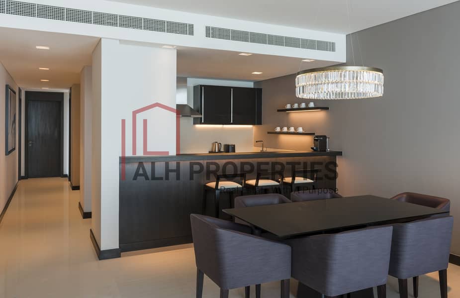 3 Sheraton Grand Hotel, Dubai - 3 Bedroom Apartment Kitchen & Dining Area. jpg
