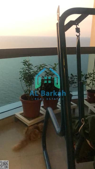 For sale in Ajman, two rooms, a hall, a bathroom, a maids room, a storeroom, and two balcony with a stunning sea view in the Corniche Tower, 835,000