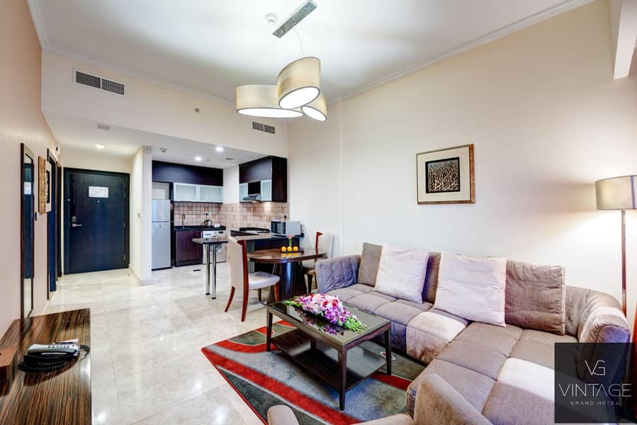 3 Ghaya Grand Hotel Dubai - One Bedroom Sitting Room 1-2. jpg