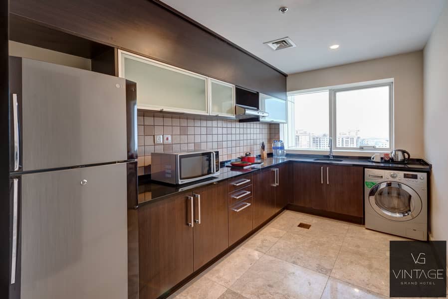 4 Ghaya Grand Hotel Dubai - Two Bedroom closed kitchen. jpg