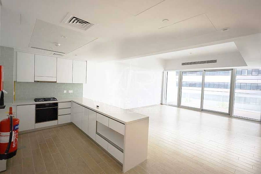 3 al-mayan-yas-island-living-room-with-open-kitchen-and-wooden-floor-and-balcony-and-central-ac-1. jpeg