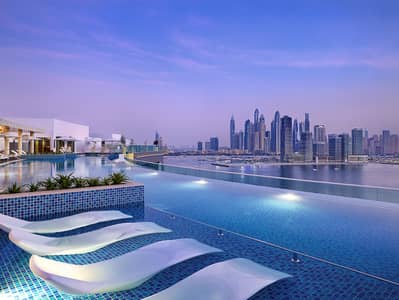 1 Bedroom Apartment for Rent in Palm Jumeirah, Dubai - NH_Collection_Dubai_The_Palm_Pool View_Evening (1). jpg