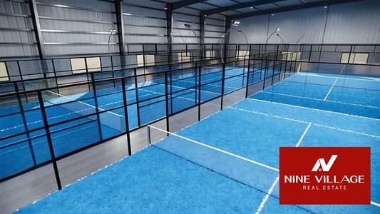 Warehouse for Rent in Al Qusais, Dubai - padel-tennis-courts-inside-empty-warehouse-sport-complex-buildings-during-the-day-video. jpeg