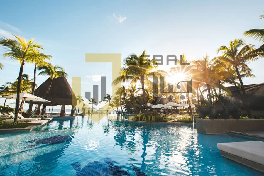 5 swimming-pool-among-palm-trees-on-a-tropical-islan-2022-02-12-05-47-40-utc. jpg