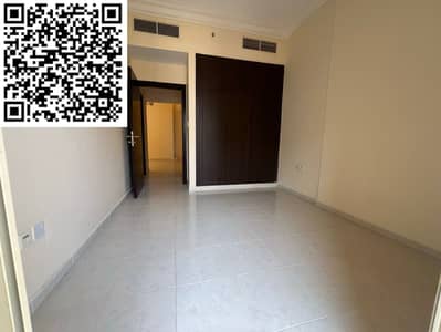 Two-bedroom apartment for annual rent in Emirates City, Ajman, with a direct location on Mohammed Bin Zayed Road, with central air conditioning and fr