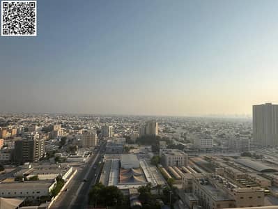 For annual rent, a two-bedroom apartment with a hall in Ajman City Towers, with an open view and free parking. The apartment is located in a strategic