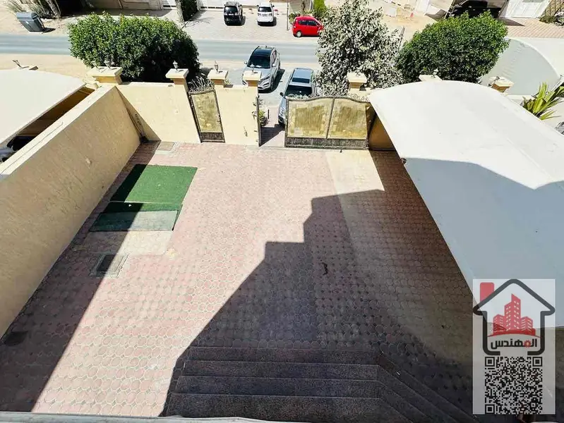 Villa for rent in Al Muwaihat 1 on the street Second occupant Area 5,000 sq ft Consisting of 5 master bedrooms, a living room, 2 halls, 2 kitchens, a maid's room, a storeroom, a spacious courtyard, a parking space, and a large setback in front of the vill - View 3
