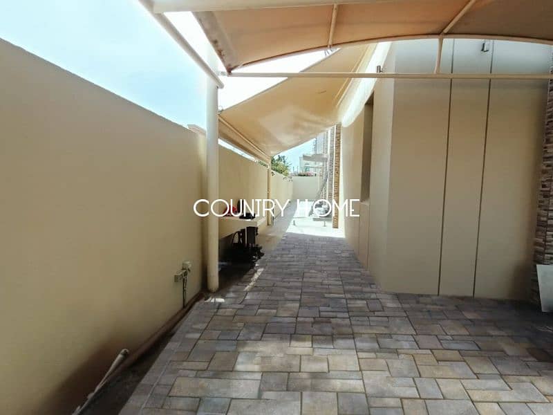 Spacious 5-BR Villa with Study, Private Garden & Close to SZR in Al Manara - Image 17