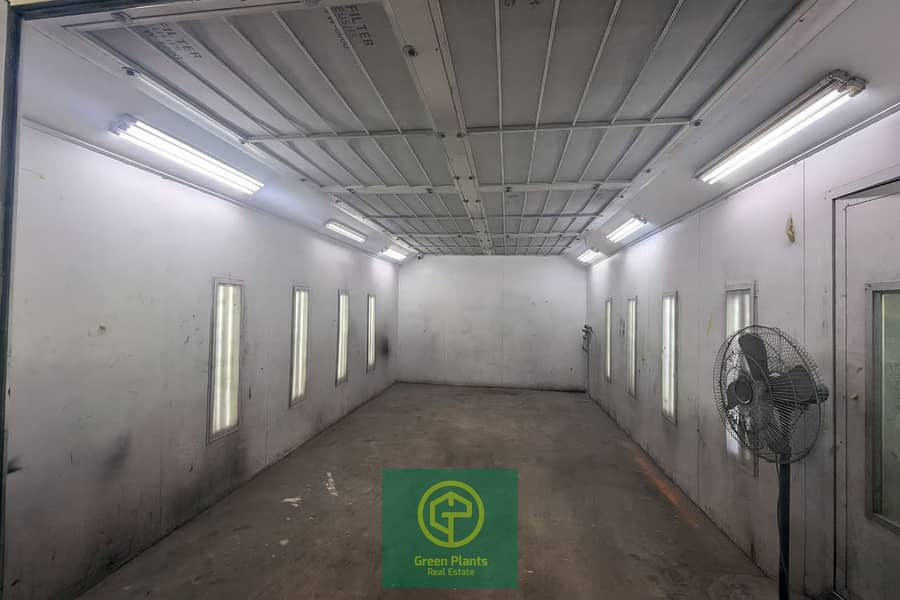 3 Empty automotive paint booth interior. png