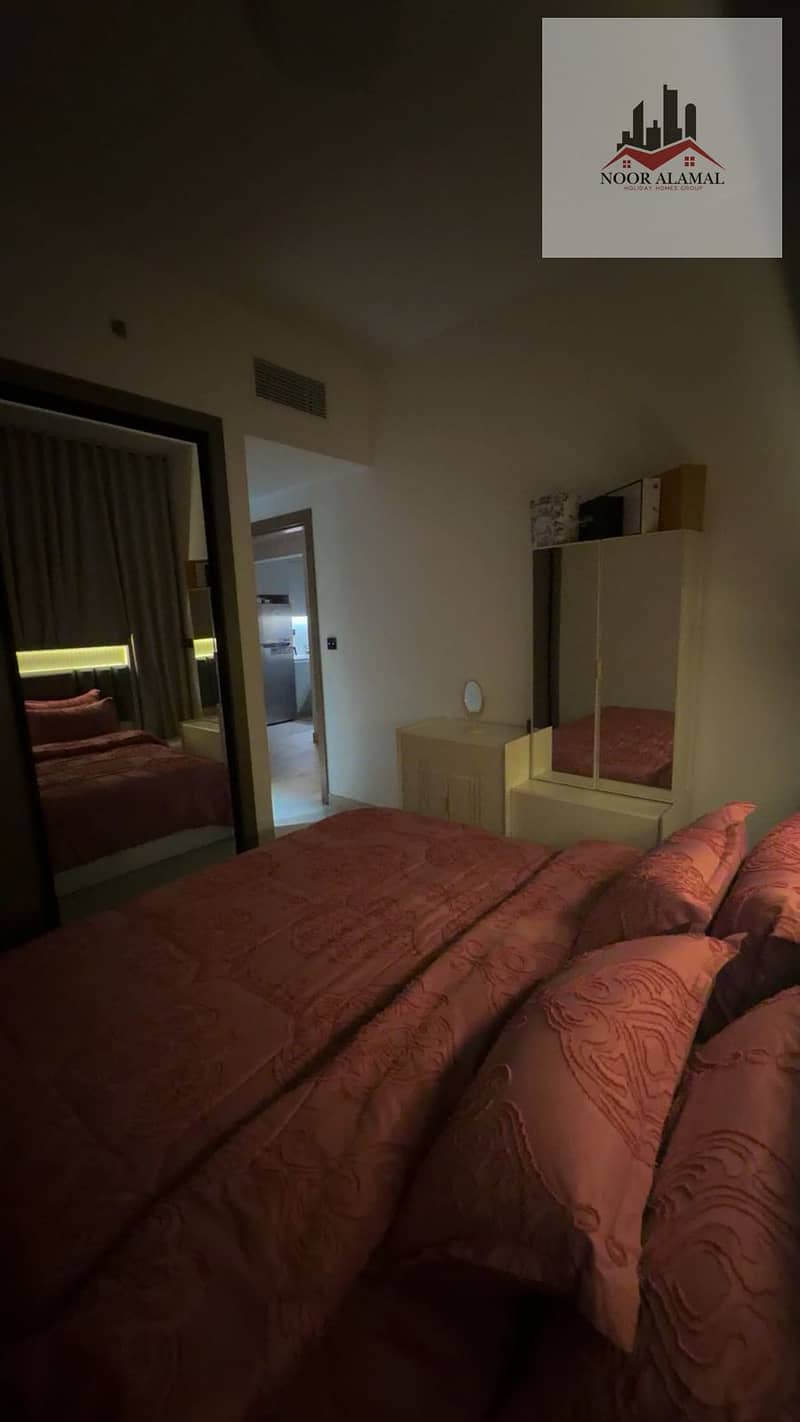 Dubai, fully furnished super deluxe apartment, second occupancy, one bedroom, living room, kitchen, and two bathrooms. Price: 10,000 AED including int