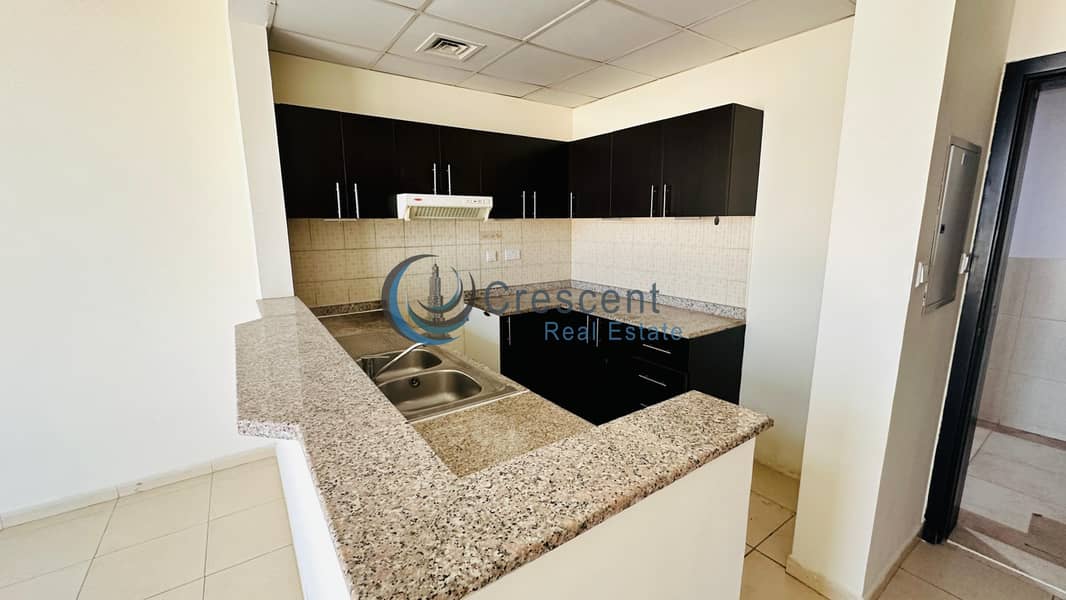 Spacious 1BR Apartment in Mazaya 23 | Liwan