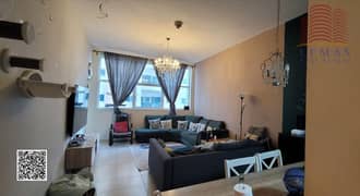 شقة فارغة للبيع في أبراج عجمان وان، تتكون من غرفتي نوم ومطبخ مفتوح وموقف سيارات