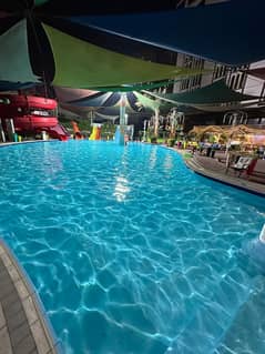 شقة غرفة وصالة للإيجار السنوي في عجمان مع جيم ومسبح واكوا بارك بناية فاخرة – خدمات متكاملة وشهر مجاني