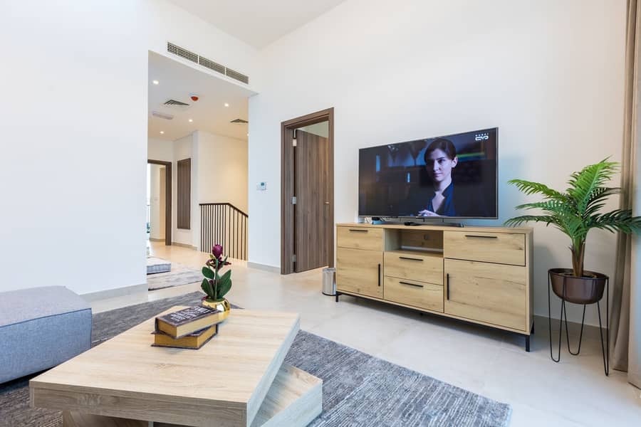 15 living room in the 1st floor with TV . jpg