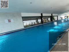 غرفه وصاله للايجار السنوي مع بلكونه 2 حمام جيم مجاني مسبح مجاني كيدز اريا اكوا بارك مجاني شهر مجاني برج جديد اطلاله مفتوحه بالكامل