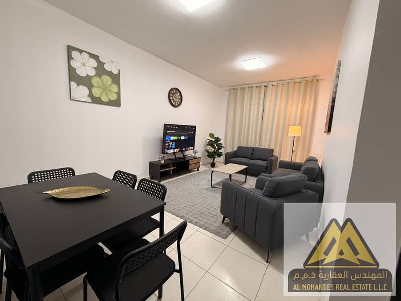 One bedroom and living room apartment with 2 bathrooms for monthly rent first tenant in Ajman Corniche sea view without balcony suitable for comforta