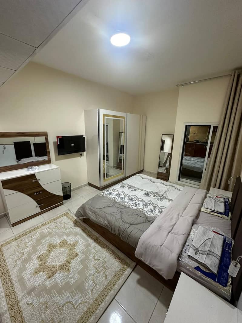 Studio apartment for monthly rent in Al Rawda, Ajman, in a prime location opposite Kenz Mall, close to all amenities such as markets, restaurants, and