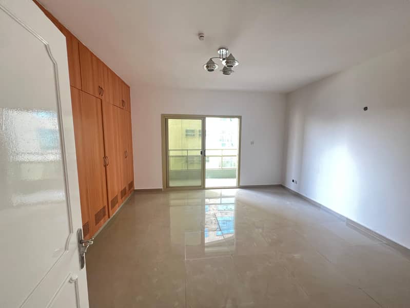 Largest two-bedroom apartment with a living room in Al Majaz 2, with free air conditioning, a balcony, and an open view