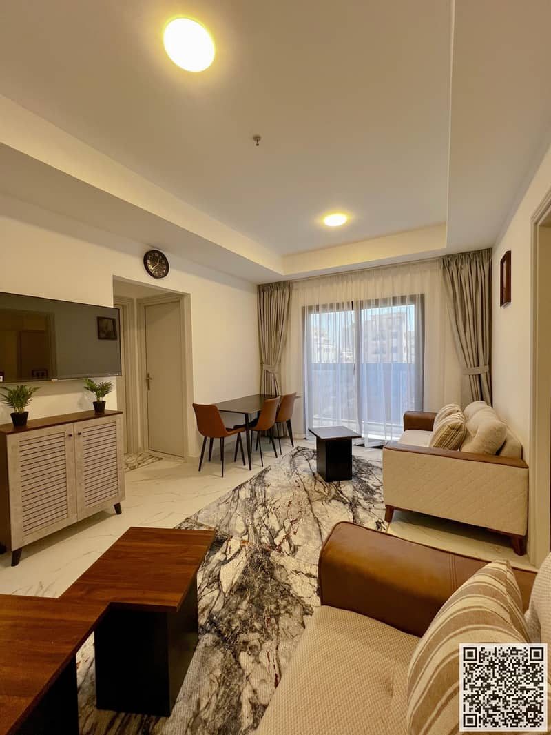 VIP Apartment One bedroom and living room with a balcony offering an open view, available for monthly rent on Ajman Corniche.